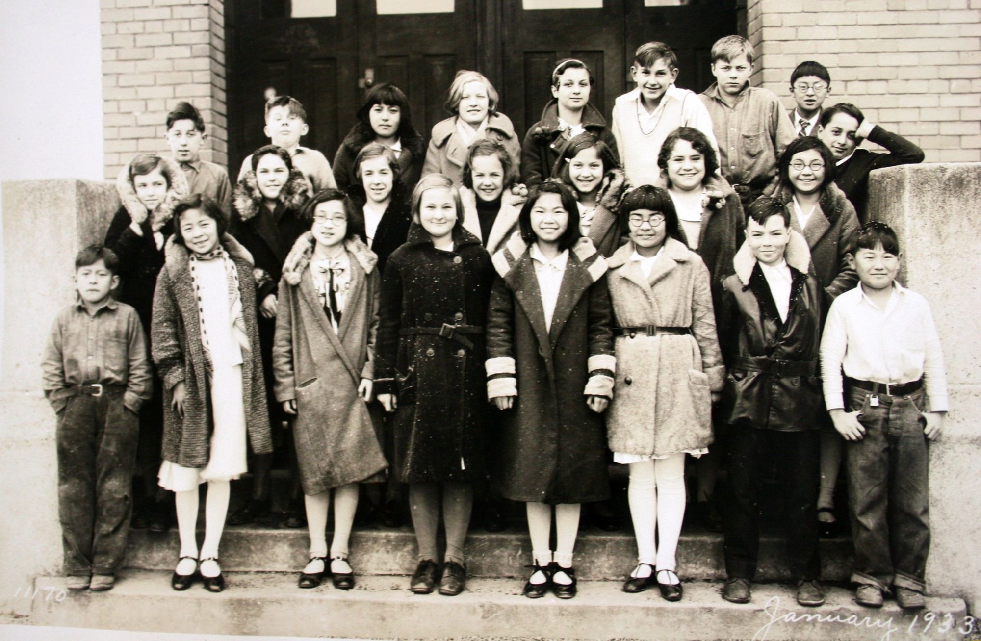 Class portrait, January 1933: students in winter coats on the main stair.