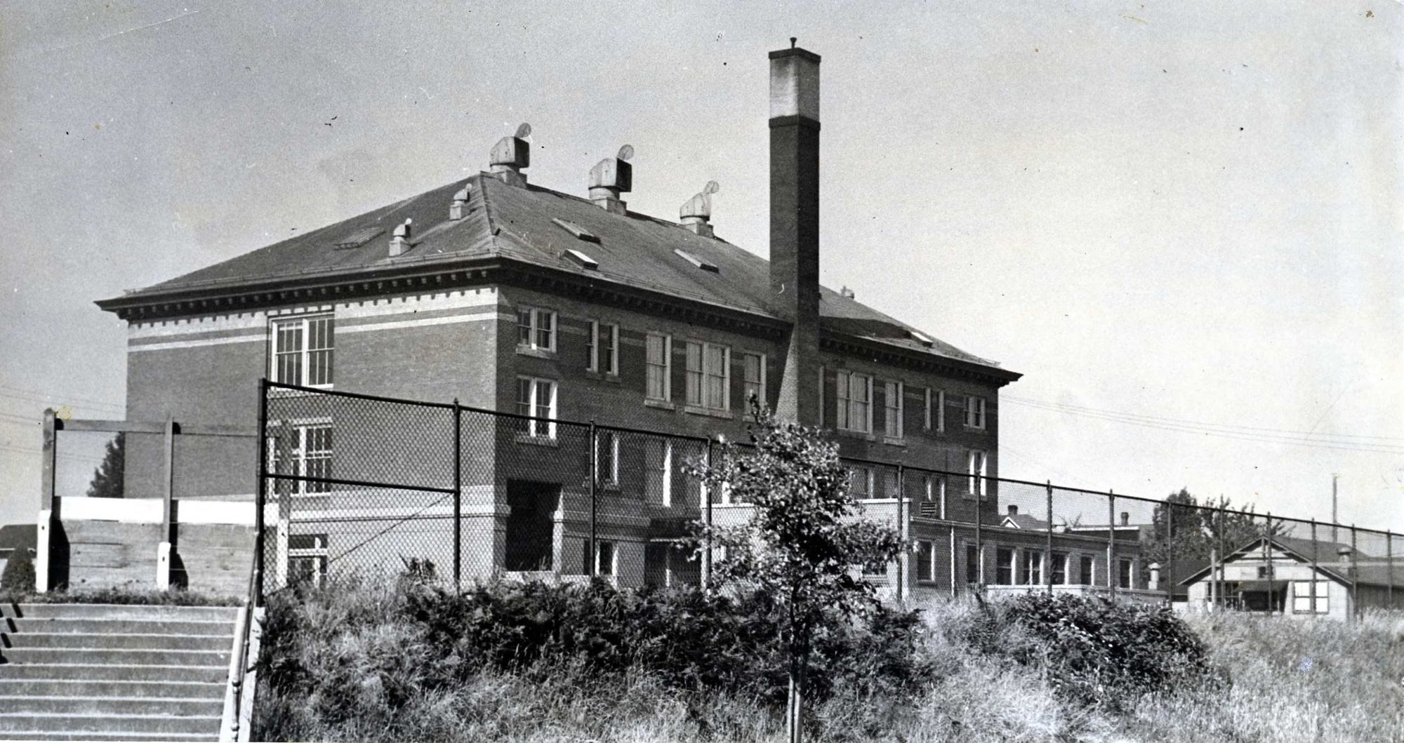 Concord School seen from the street below, with concrete steps climbing the slope.
