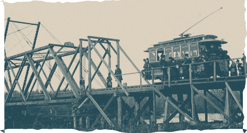 A streetcar crossing a timber bridge over the Duwamish.